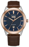 Gents Citizen Watch AW0096-06L. This Corso model is shown in a two-tone rose gold-tone and white stainless steel case, brown leather band, and a navy blue dial with a day and date window. Features include: Eco-Drive technology, sapphire crystal, and water resistance up to 100 meters. 